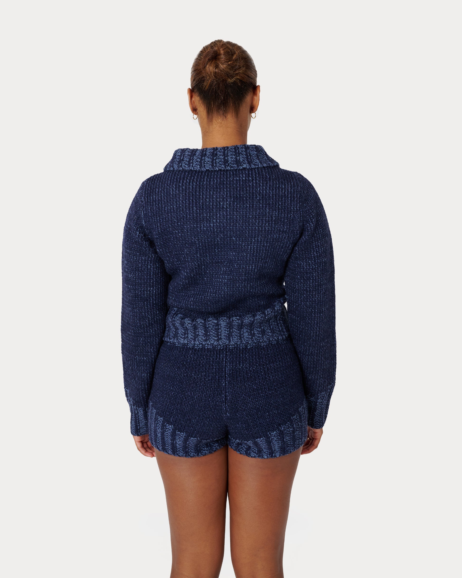 Model is wearing a size Medium in Zaya Knit Shorts in Dark Blue by Aseye Studio